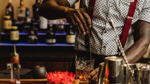 A bartender pouring a drink into a glass. - Hyatt Regency Austin (Austin)