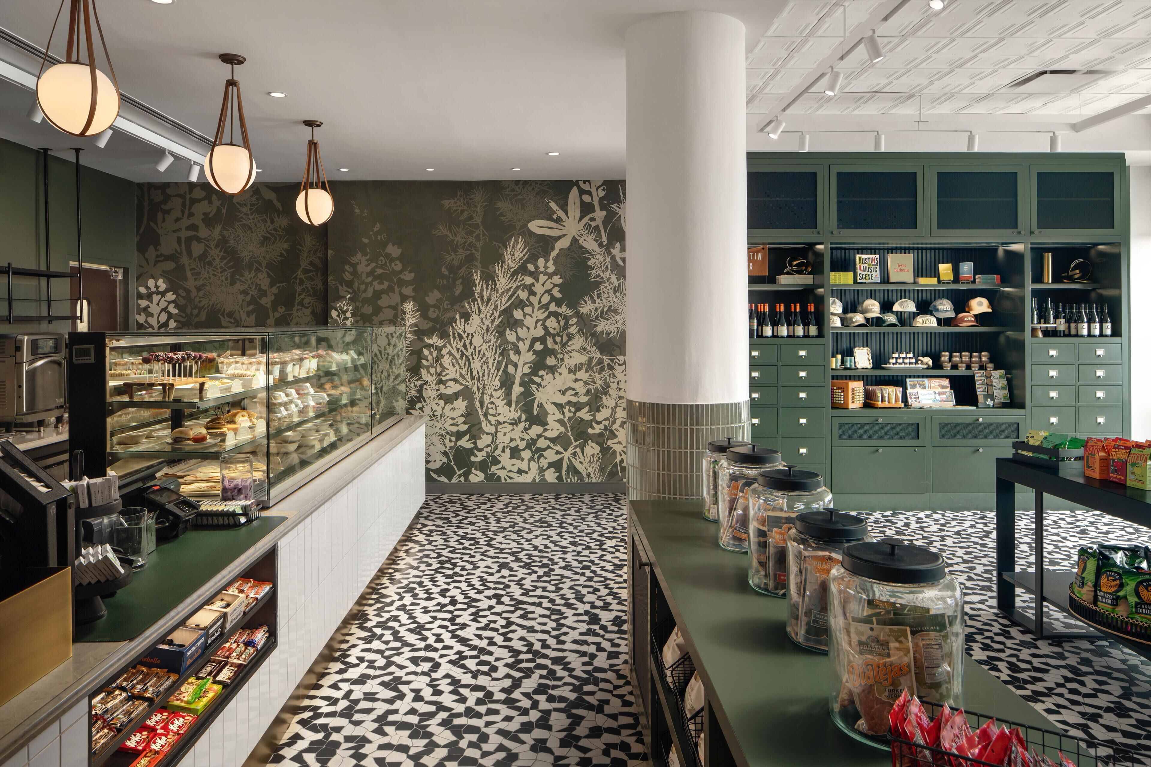 A bakery counter with pastries and a display of baked goods.