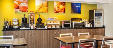 A modern breakfast bar with a variety of food items and a coffee machine.