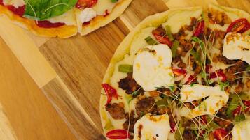 Dos pizzas sobre una tabla de madera.