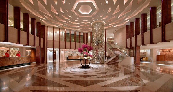 A spacious lobby with a central column, a reception desk, and a staircase. - Mandarin Oriental, Jakarta (Jakarta)