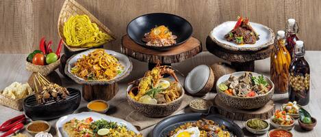 A variety of dishes and condiments arranged on a wooden table.