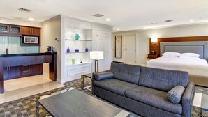 A hotel room with a kitchenette, a sofa, a bed, and a bathroom. - DoubleTree by Hilton Hotel Toronto Downtown (Toronto)