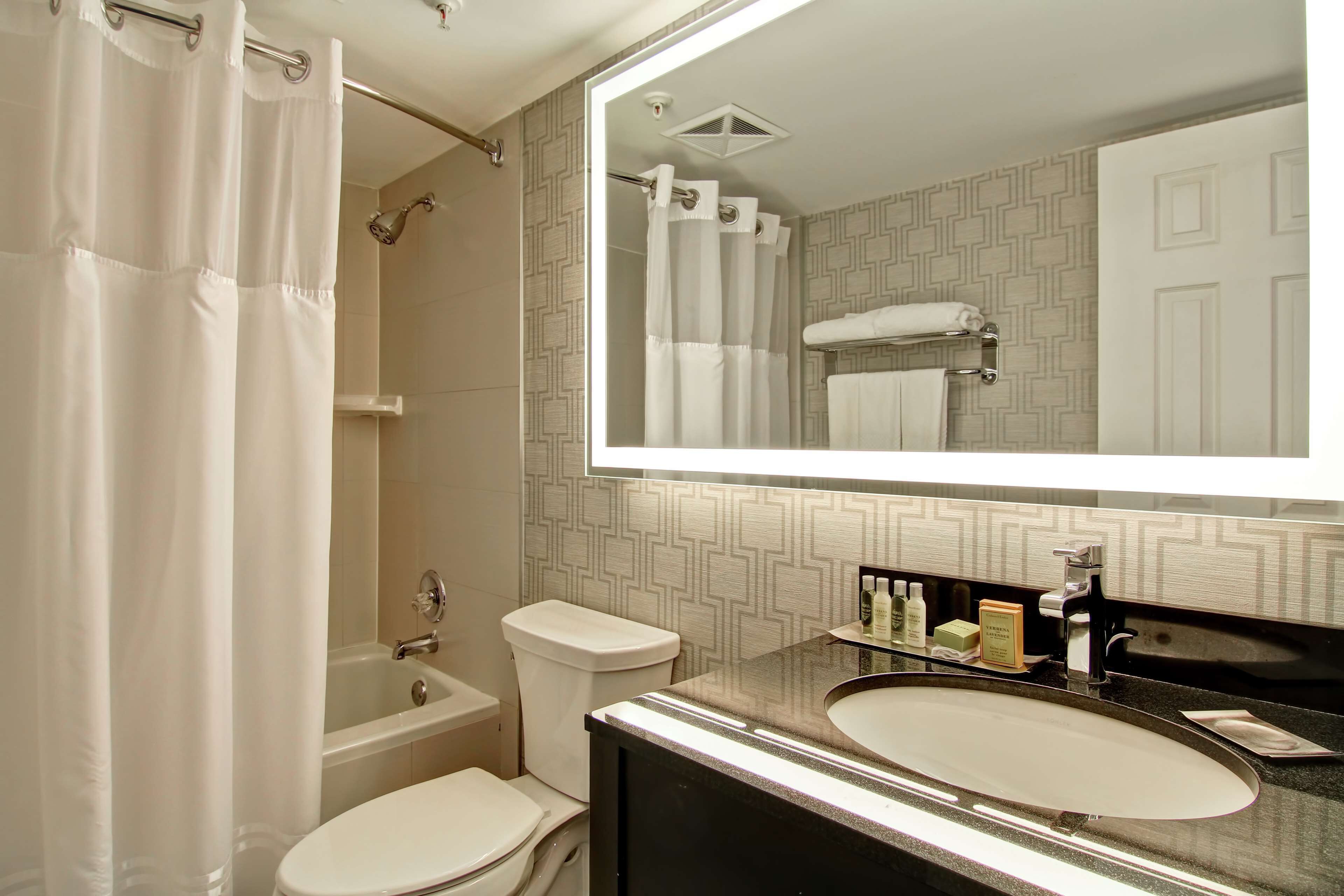 A bathroom with a bathtub, toilet, and sink.