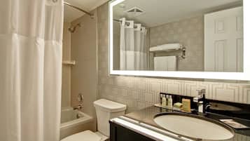 A bathroom with a bathtub, toilet, and sink.