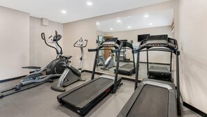 A gym with treadmills, an elliptical, and a stationary bike. - Sleep Inn Billings (Billings)