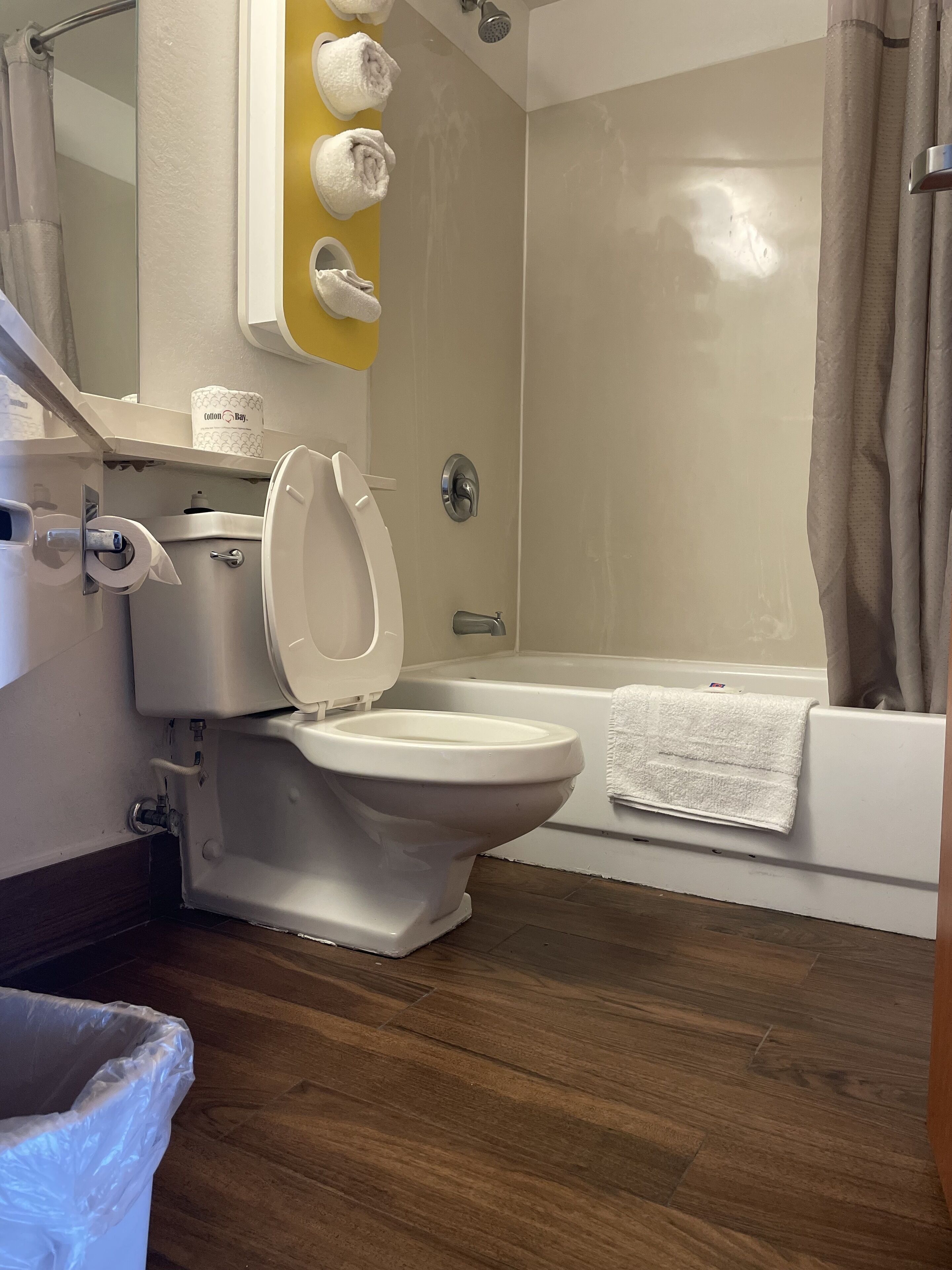 A bathroom with a toilet, shower, and bathtub.