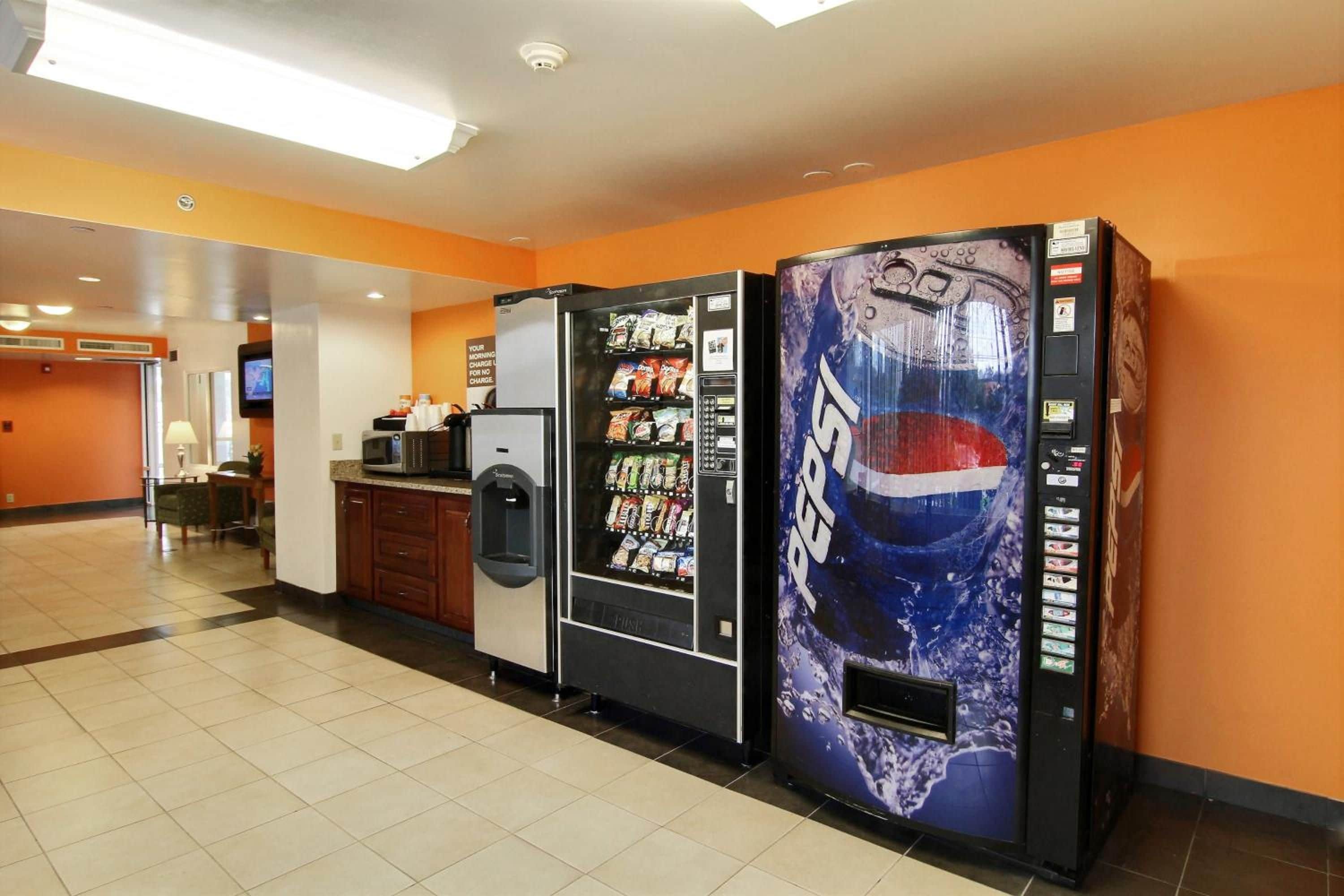 A vending area with a Pepsi machine and a microwave.