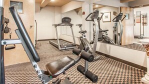 A gym with treadmills, weight machines, and a mirror reflecting the equipment. - Quality Inn near Toms River Corporate Park (Manchester Township)