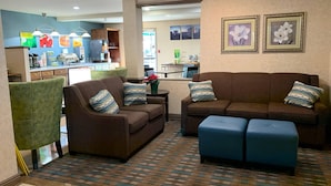 A living room with two sofas, a coffee table, and a patterned rug. - Quality Inn near Toms River Corporate Park (Manchester Township)