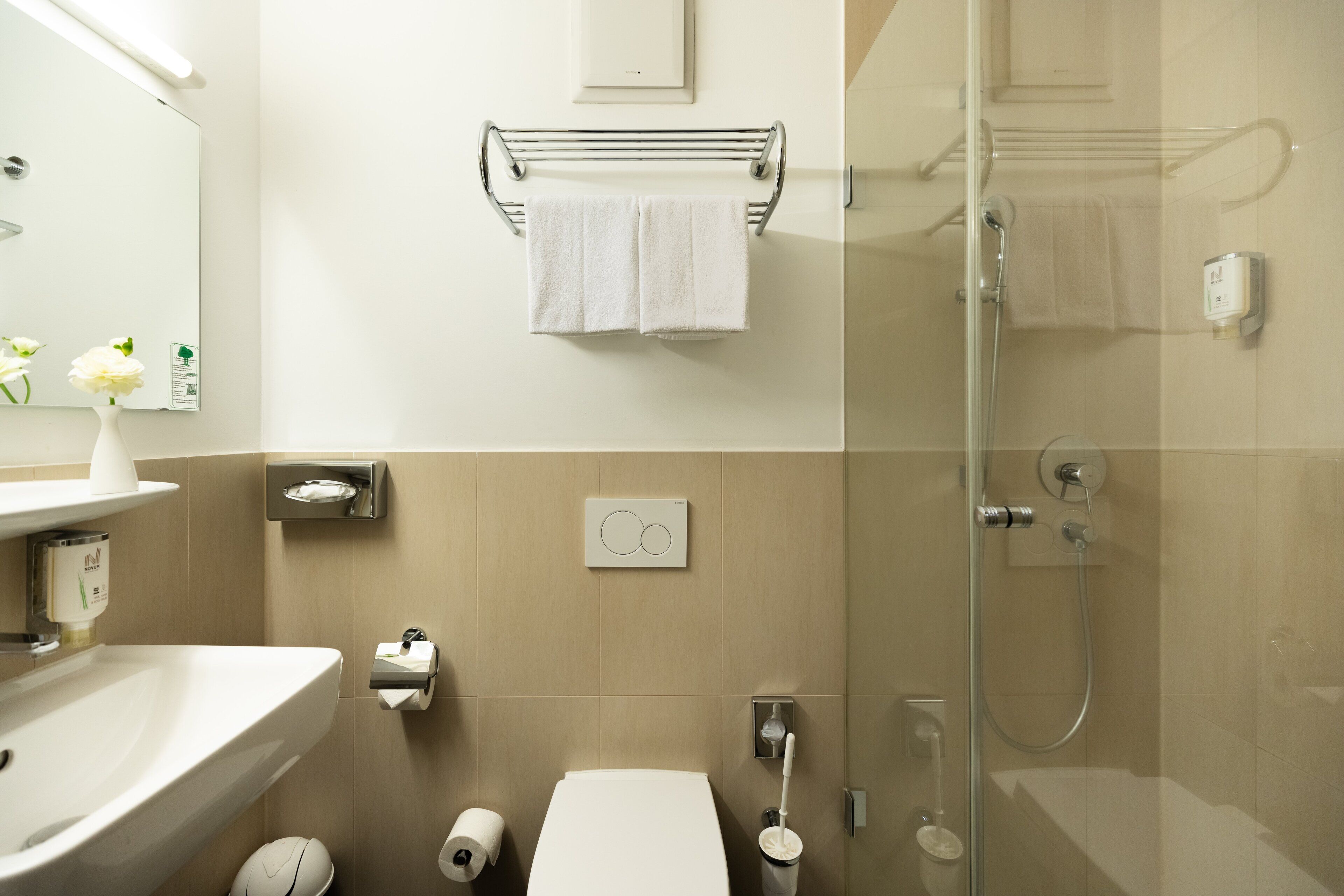 A modern bathroom with a sink, toilet, and shower.