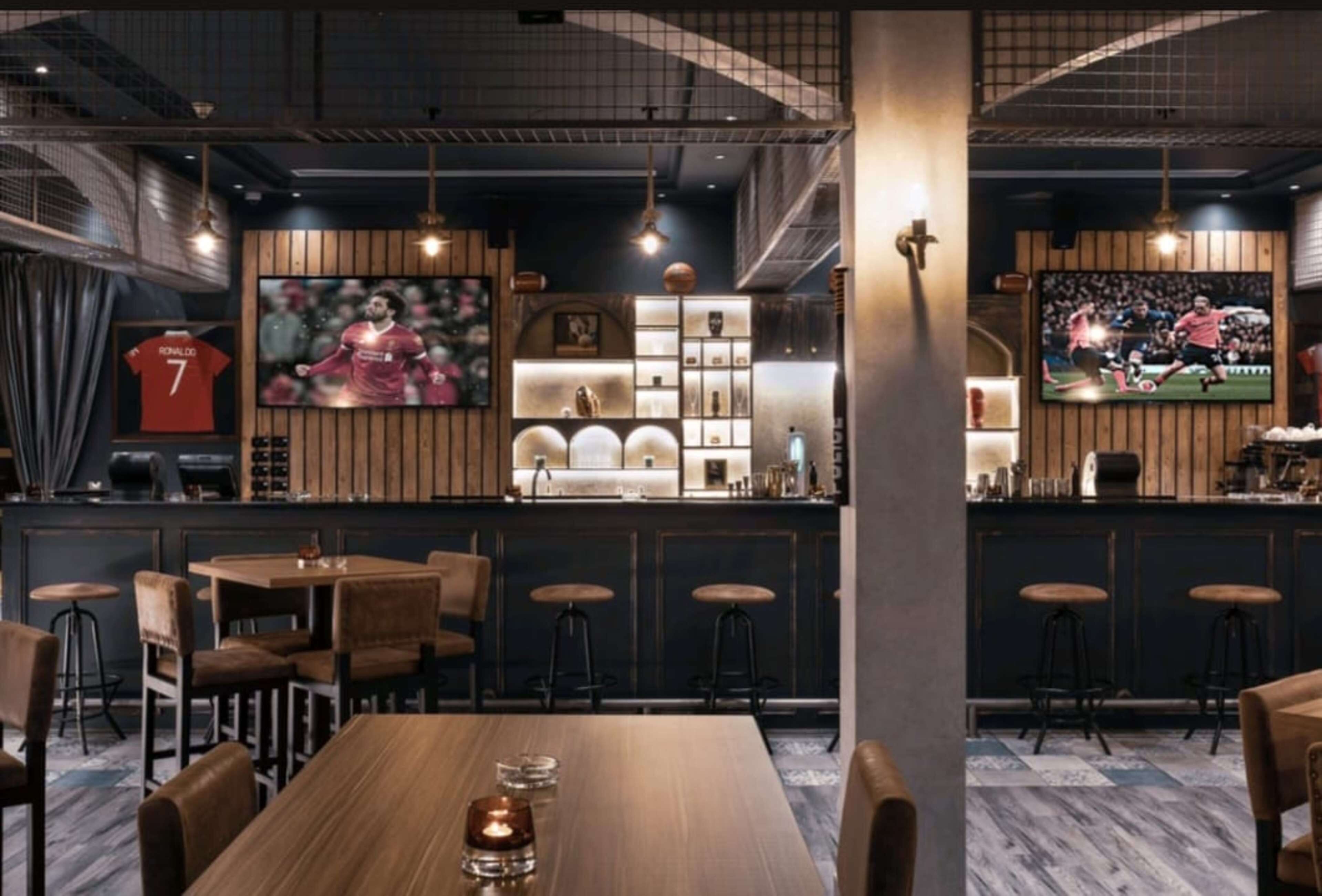 A restaurant with a bar area, wooden furniture, and sports memorabilia.