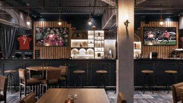 A restaurant with a bar area, wooden furniture, and sports memorabilia.