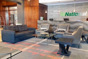 Welcome to our reception area, featuring a comfortable sofa, armchairs, and a coffee table.