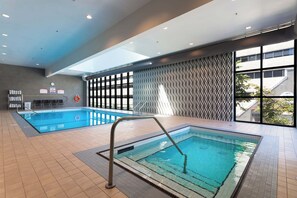 Swim laps in the hotel's rectangular pool surrounded by a geometric patterned design.