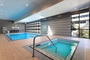 Swim laps in the hotel's rectangular pool surrounded by a geometric patterned design.
