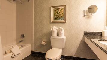A bathroom with a bathtub, toilet, and sink.