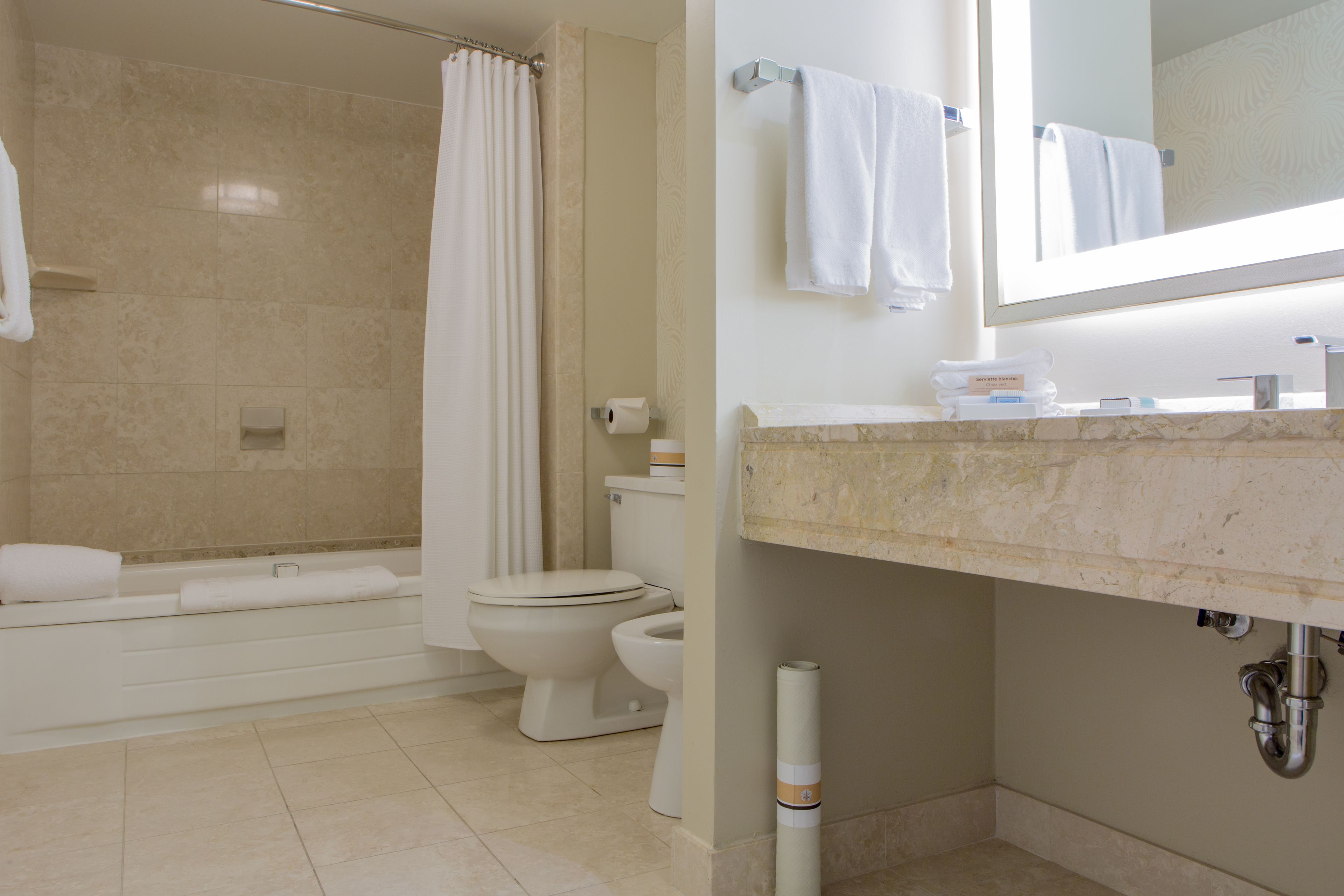 A bathroom with a bathtub, toilet, and sink.