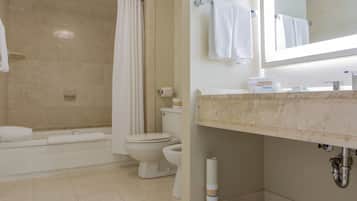 A bathroom with a bathtub, toilet, and sink.