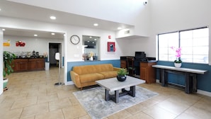 A spacious living area with a sofa, coffee table, and a kitchen area with a dining table and chairs. - Quality Inn Holbrook near Petrified Forest (Holbrook)