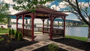 A gazebo with a red roof and wooden structure, surrounded by a landscaped garden with gravel paths and small shrubs. - Red Roof Inn PLUS+ Secaucus - Meadowlands - NYC (Secaucus)