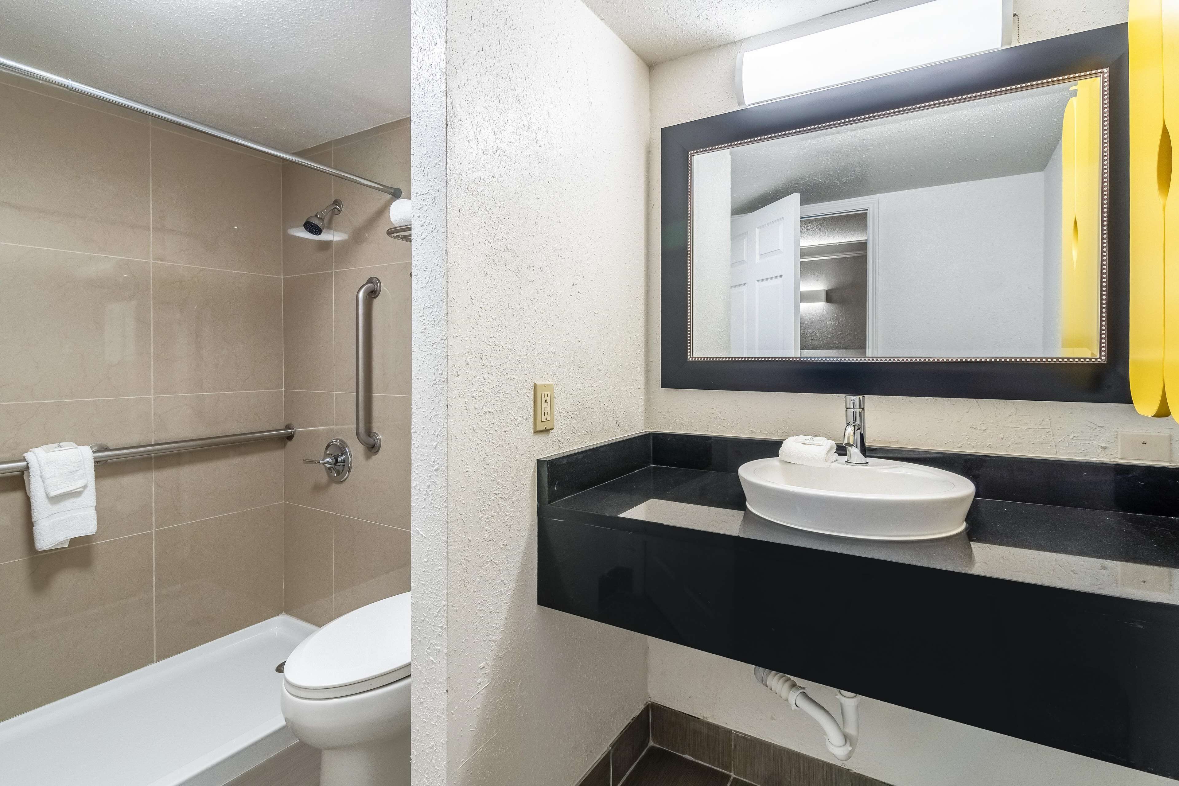 A bathroom with a bathtub, toilet, and sink.