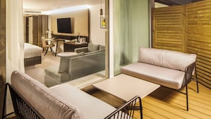 A modern hotel room with a bed, a sofa, a small table, and a TV. - Holiday Inn Milton Keynes - Central by IHG (Milton Keynes)