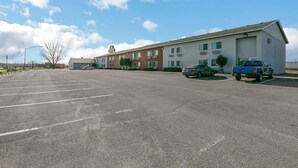 A parking lot with a building in the background.