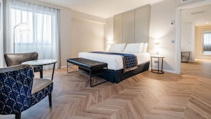 A hotel room with a large bed, a desk, a chair, and a small table. - Eurostars Gran Hotel Lugo (Lugo)