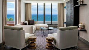 A modern living room with a sofa, armchairs, a coffee table, and a view of the ocean. - Parklane, a Luxury Collection Resort & Spa, Limassol (Limassol)