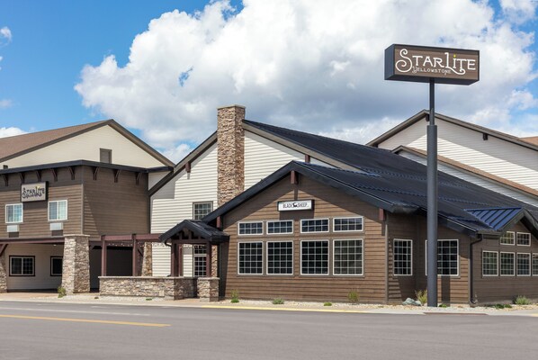 A building with a sign reading 'Starlite Yellowstone' and another sign for 'Black Sheep.'