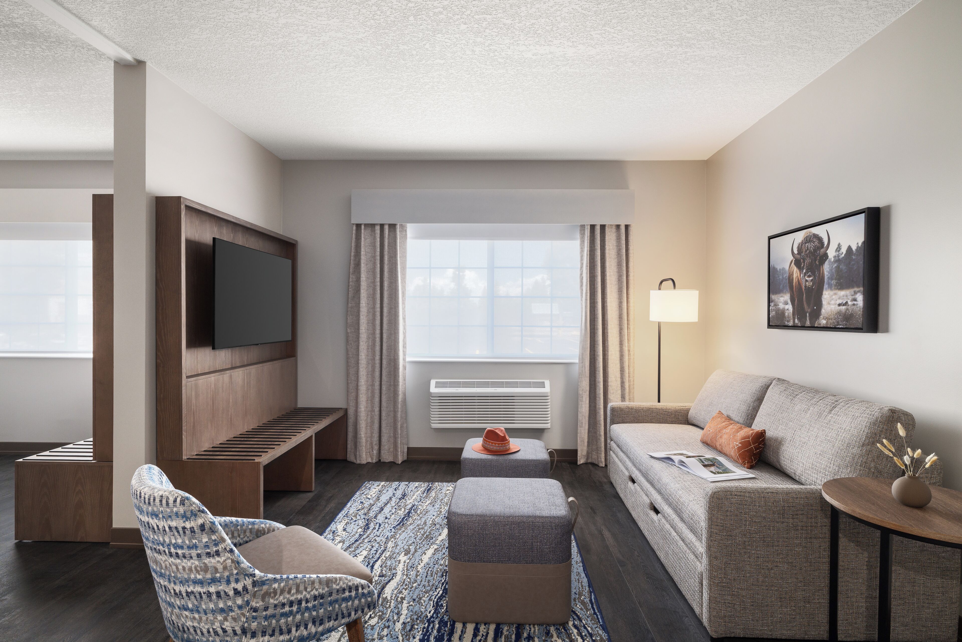 junior suite, multiple beds | living area | 32-inch flat-screen tv with satellite channels, tv, books