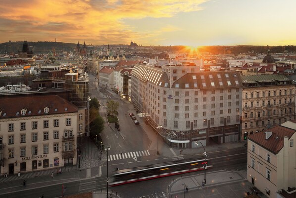 A cityscape with a tram, historic buildings, and a clear sky.