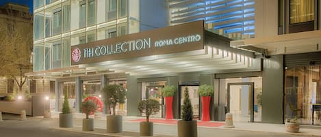A modern hotel with a prominent sign reading "NH COLLECTION ROMA CENTRO".