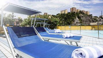 Seasonal outdoor pool, open noon to 8:00 PM, pool umbrellas