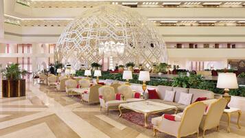A spacious lobby with a large decorative dome, comfortable seating, and a reception area.