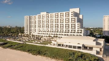 A large hotel with multiple floors, a beachside location, and a landscaped courtyard.