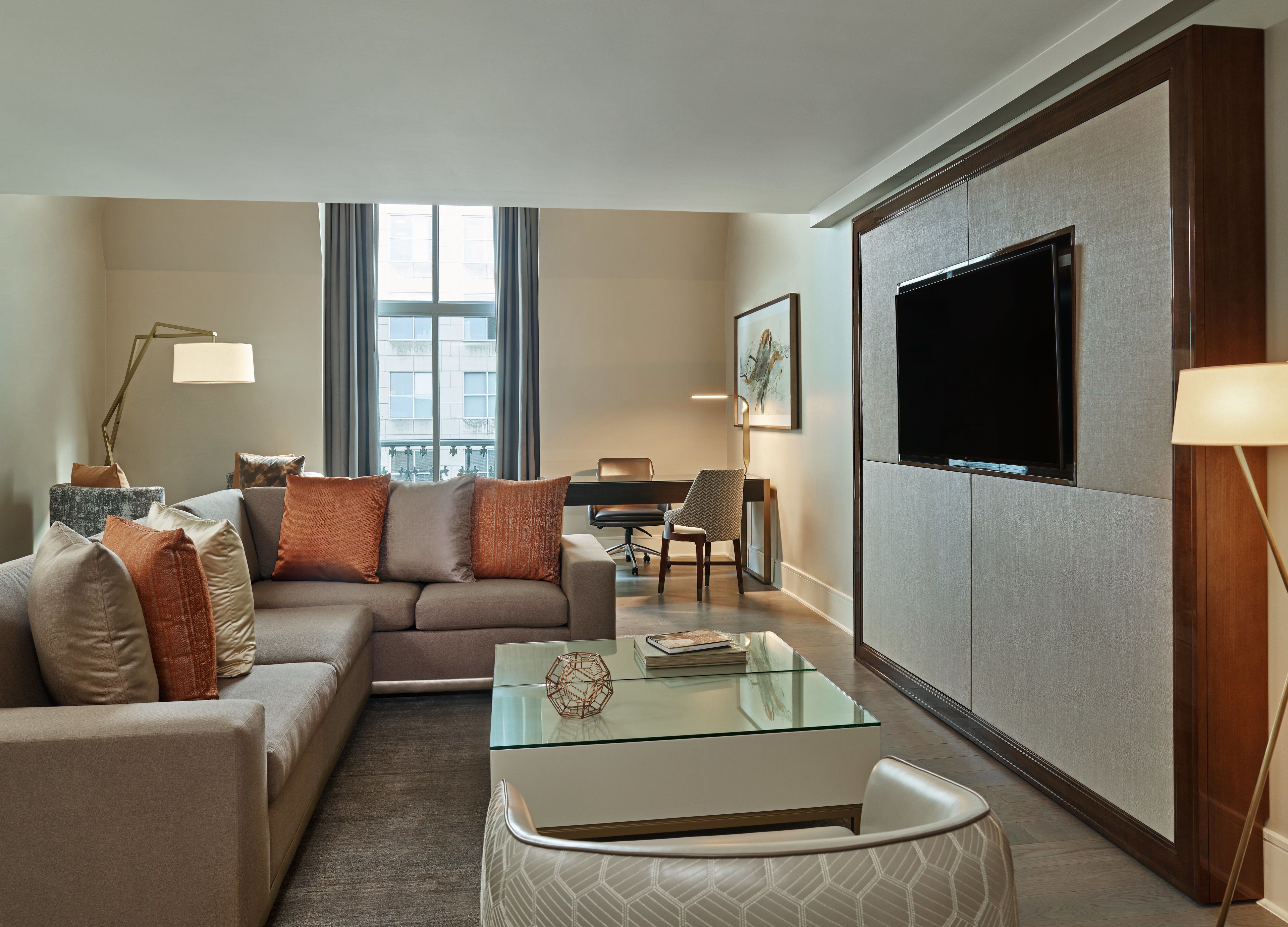 A modern living room with a sofa, coffee table, and TV.