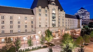 A large, historic building with a symmetrical facade, multiple windows, and a central entrance. - Hotel Crescent Court (Dallas)
