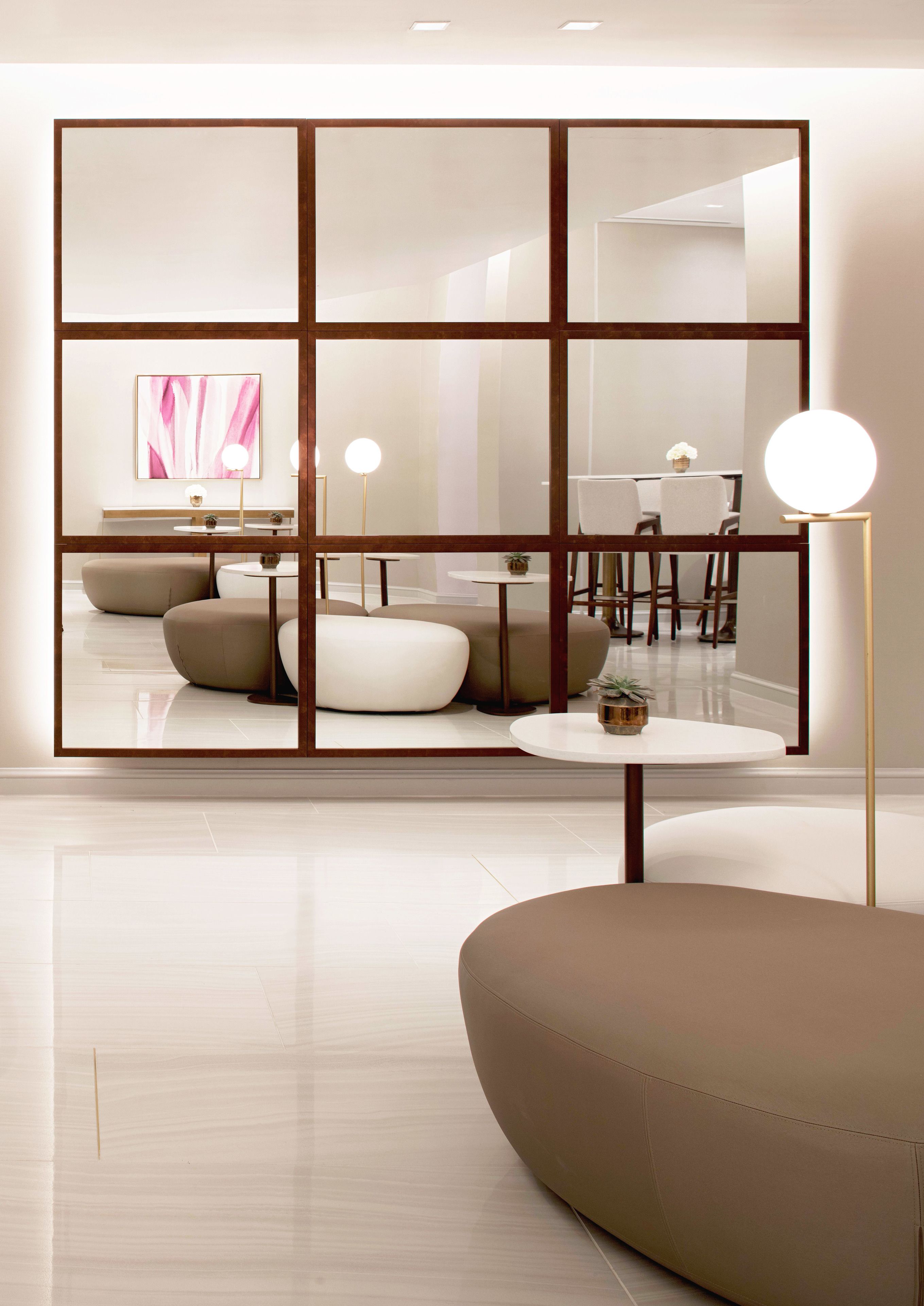 A modern living room with a sectional sofa, a round coffee table, and a floor lamp.