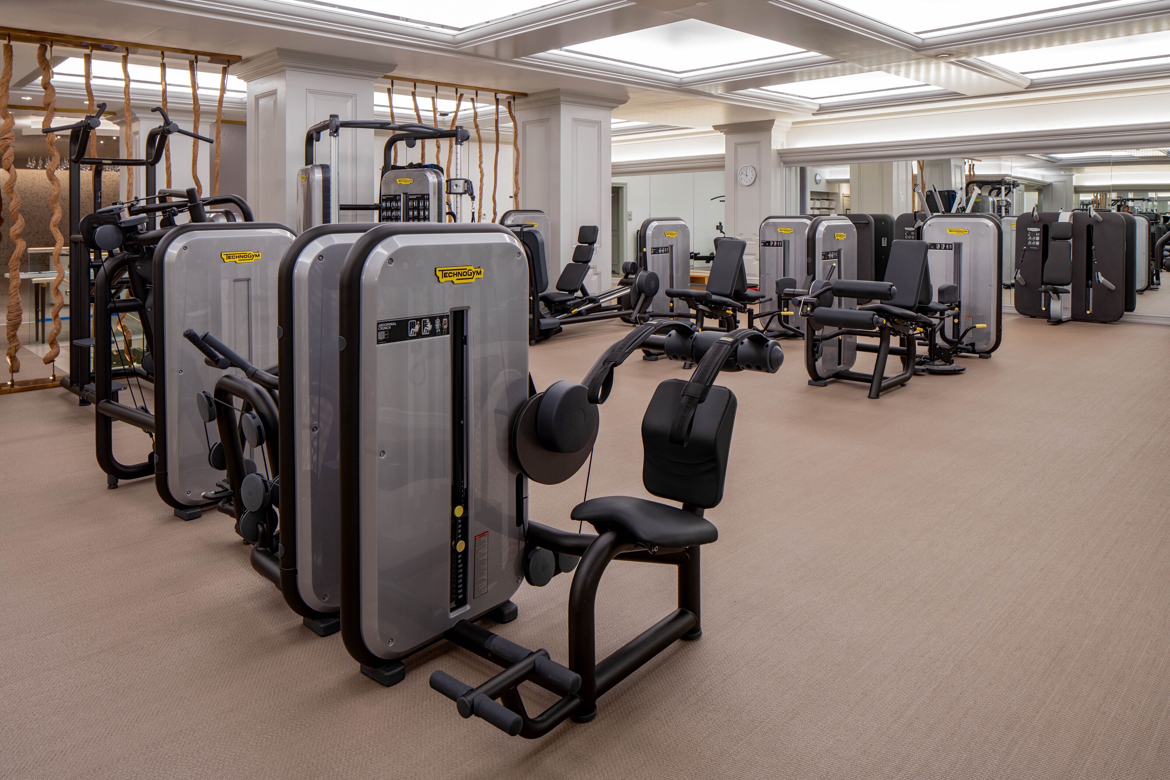 A gym with various exercise machines, including weight benches and cardio equipment.