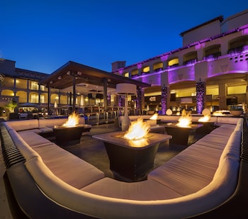 A narrow courtyard with a water feature, stone steps, and a brick wall. at Fairmont Scottsdale Princess