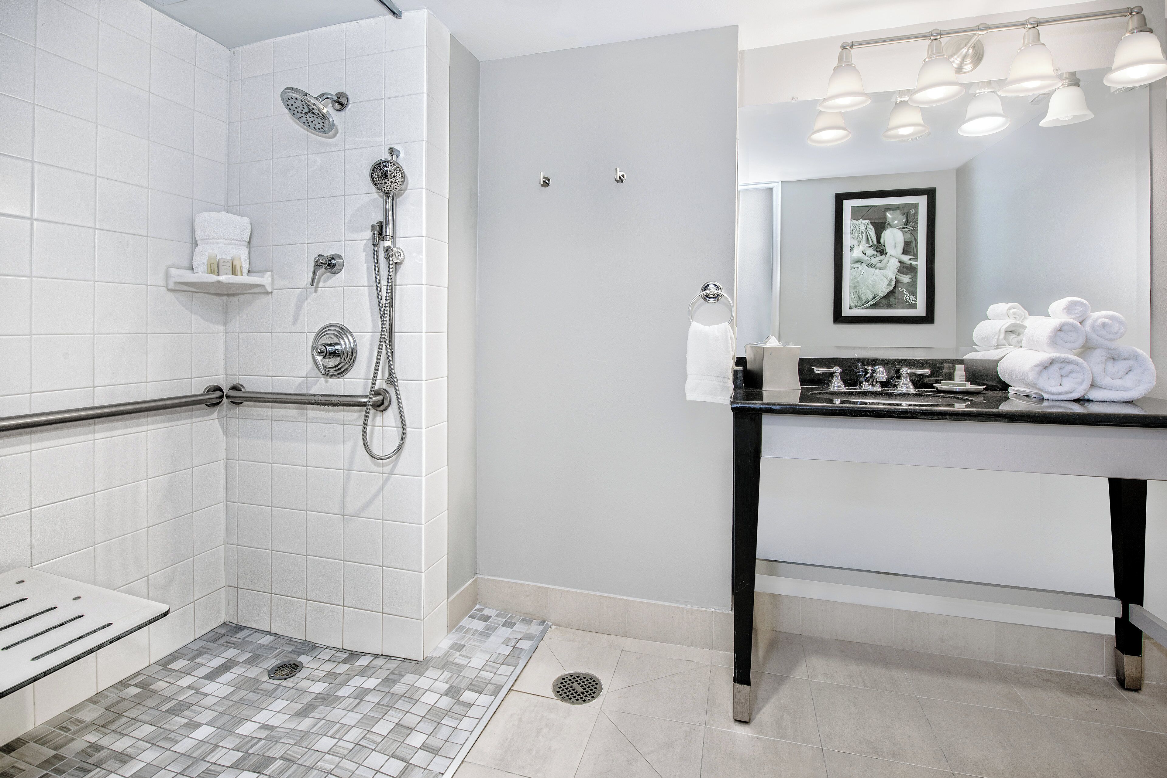 A modern bathroom with a shower, toilet, and sink.