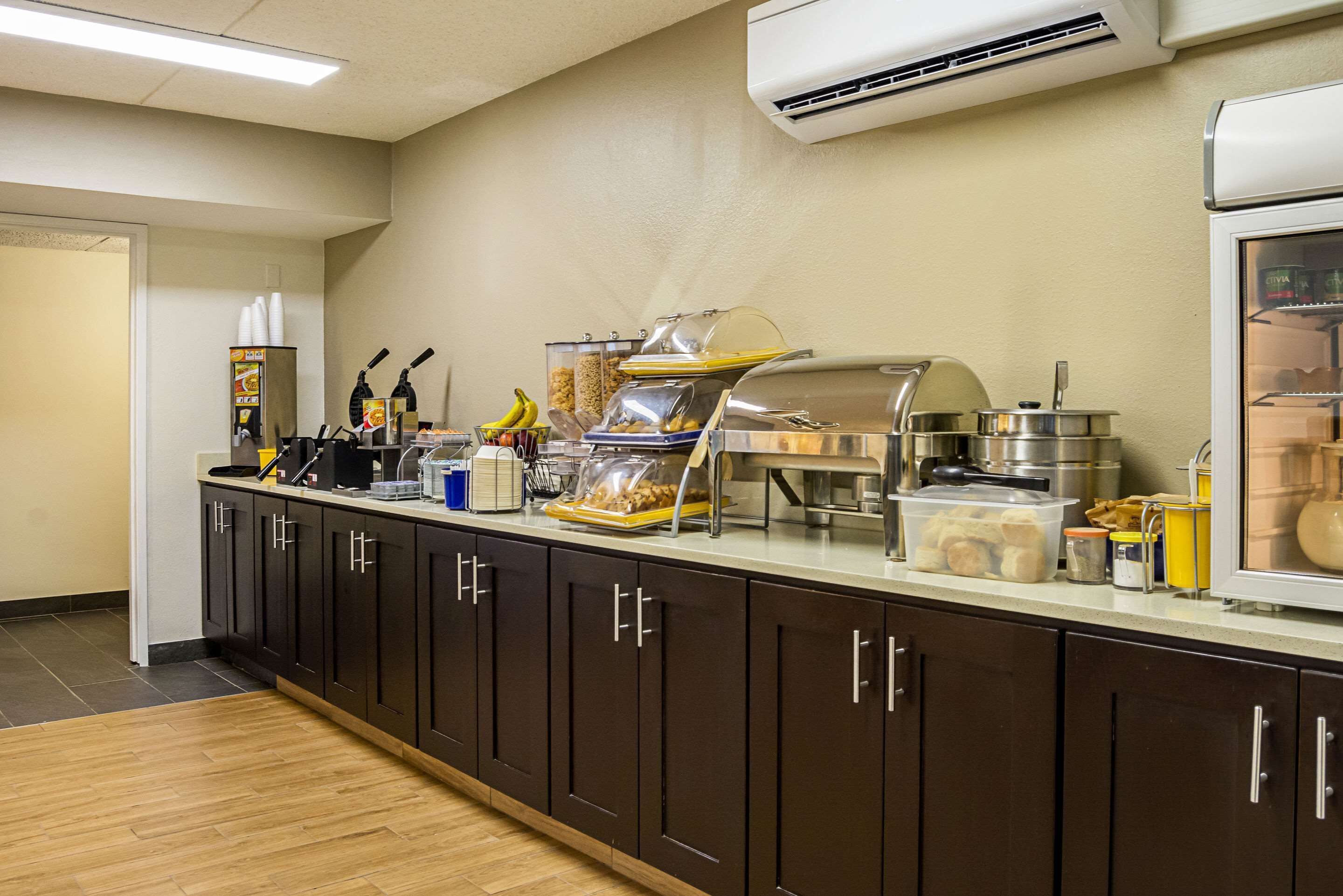 A buffet setup with various food items and utensils.