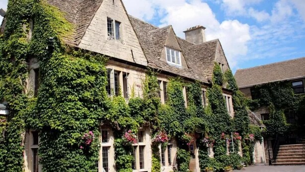 A stone building with ivy-covered walls and multiple windows, likely a hotel or historic building. - Hatton Court (Gloucester)