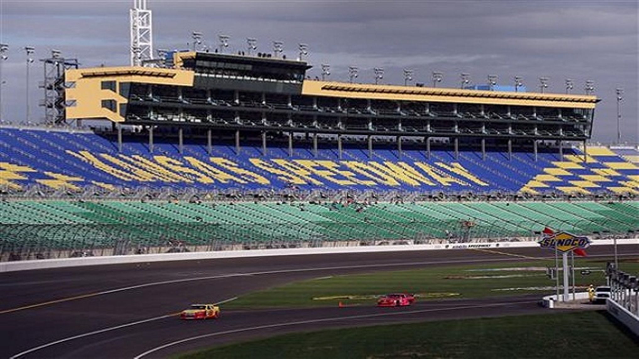 A large stadium with multiple levels of seating and a track for racing events.