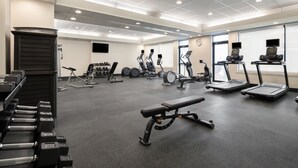 A gym with treadmills, elliptical machines, and free weights. - Holiday Inn Ontario by IHG (Ontario)