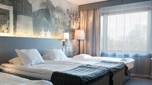 A hotel room with two beds, a large wall mural, a window with sheer curtains, and a bedside lamp. - Scandic Park Helsinki (Helsinki)