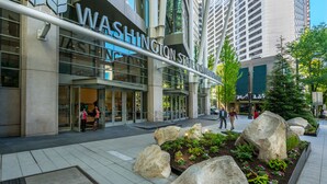 A modern building with a large sign reading "WASHINGTON STATE CONVENTION CENTER". - Hotel Sorrento (Seattle)