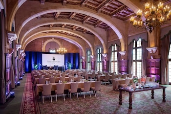 A grand lobby with a large chandelier, ornate columns, and a patterned floor. at Biltmore Hotel - Miami - Coral Gables